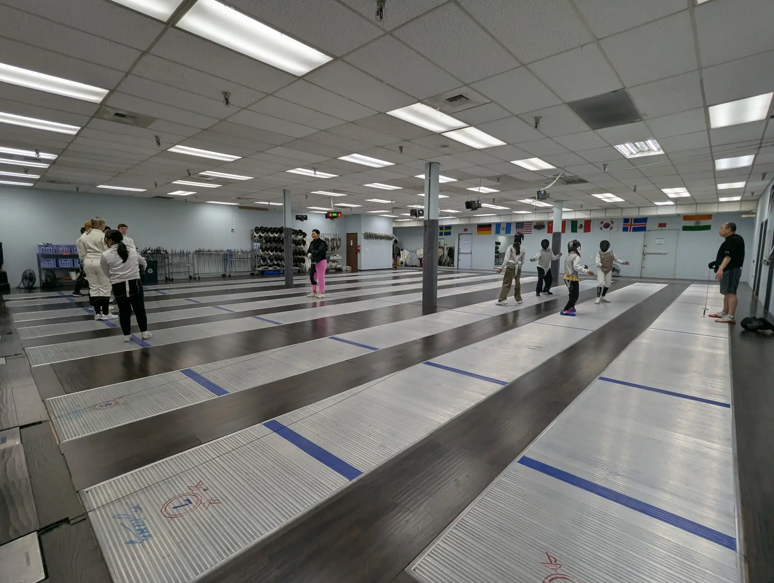 Fencing strips with foil and epee coaches and fencers